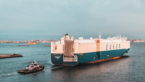 Free White and Green Cruise Ship on Sea Stock Photo
