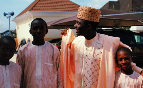 Free A cheerful African family poses together outdoors in traditional attire, creating a joyful moment. Stock Photo