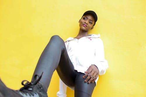 black woman leaning on wall