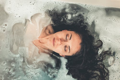 Woman in White Dress in Bath Tub