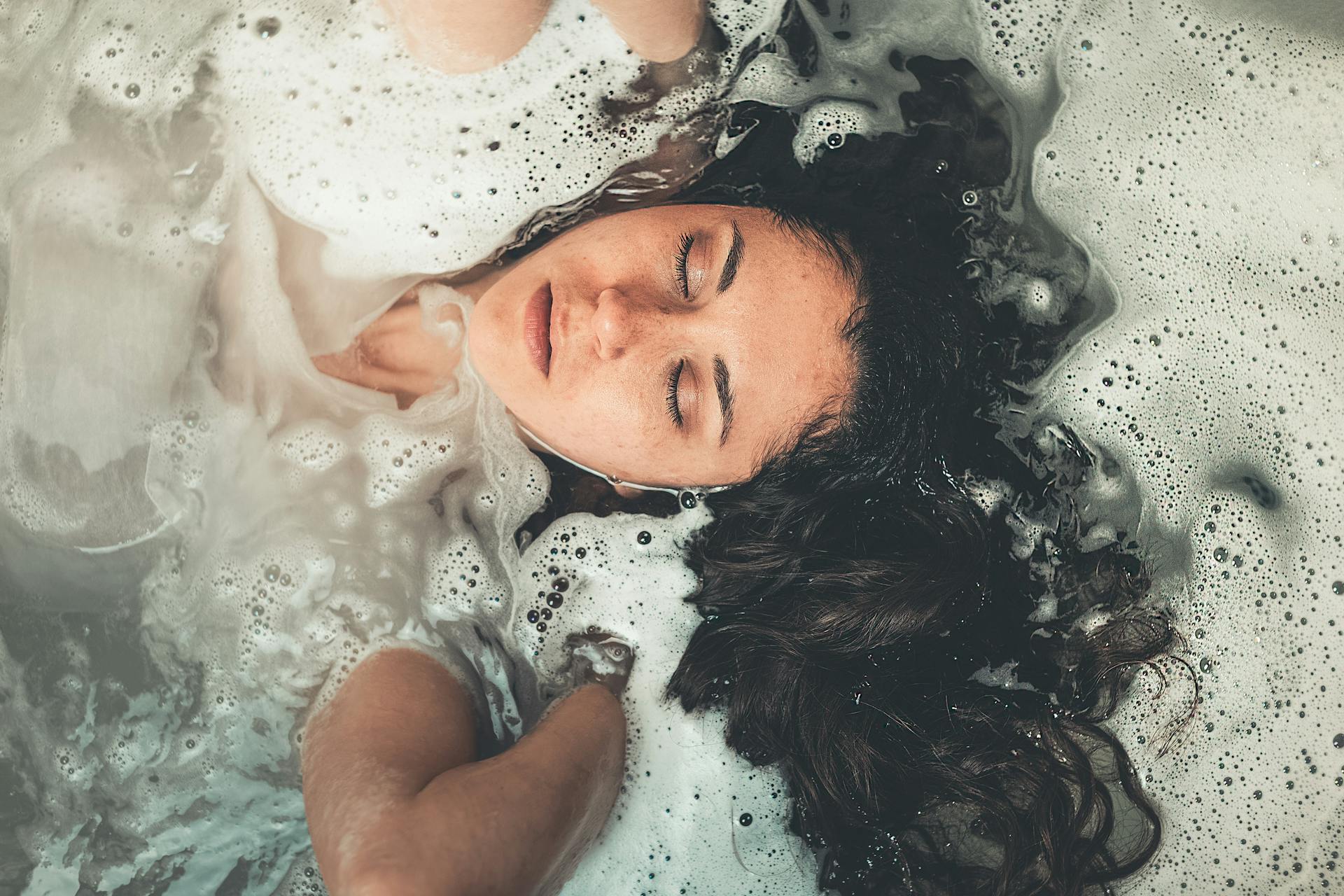 Woman Soaked in Water With Bubbles