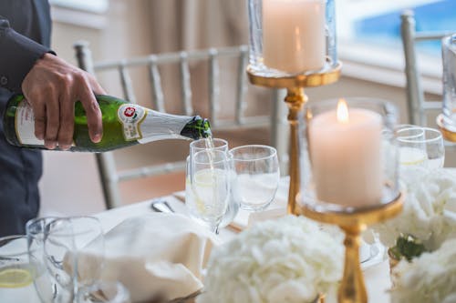 Person Pouring Champagne into Glass