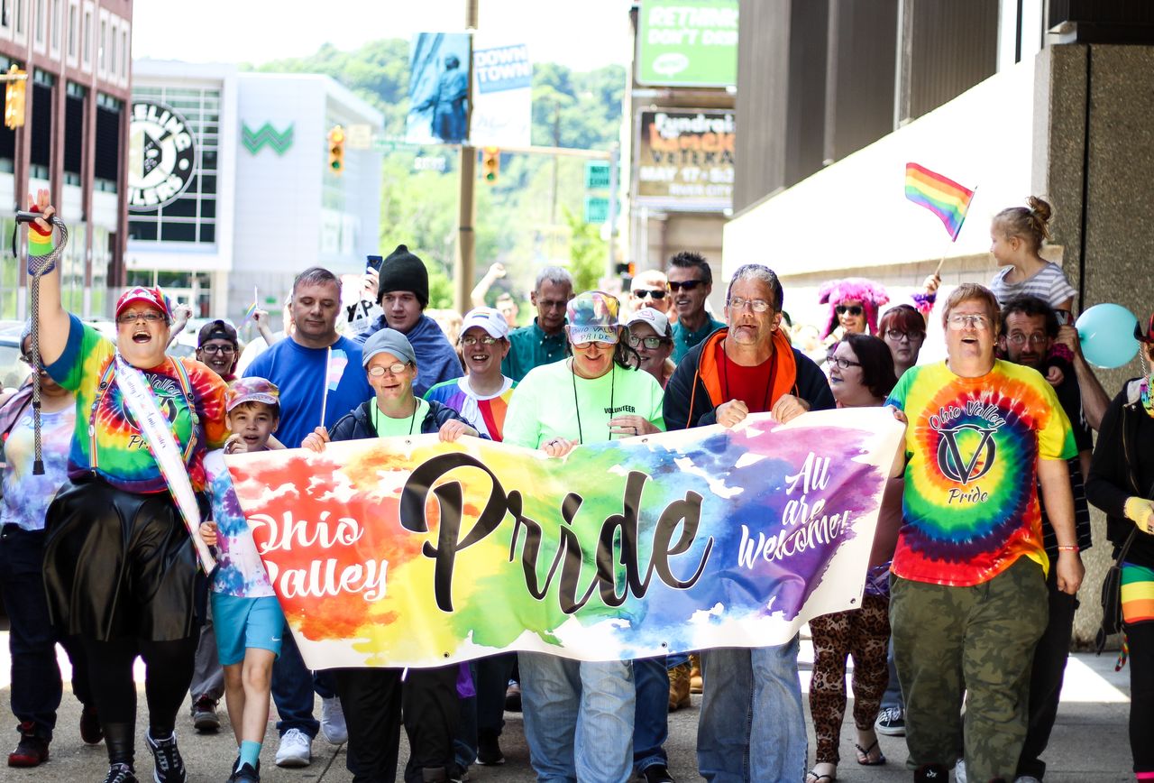 a lively crowd celebrates lgbtq pride with colorful banners in ohio va