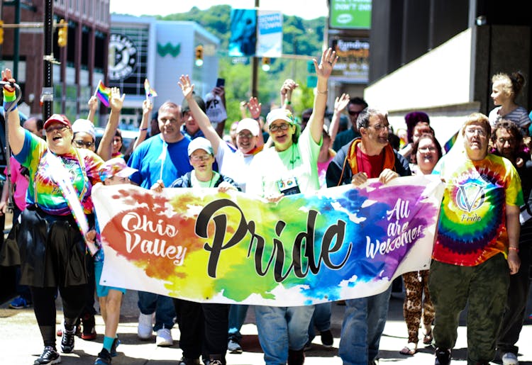 Group Of People Parading In Street