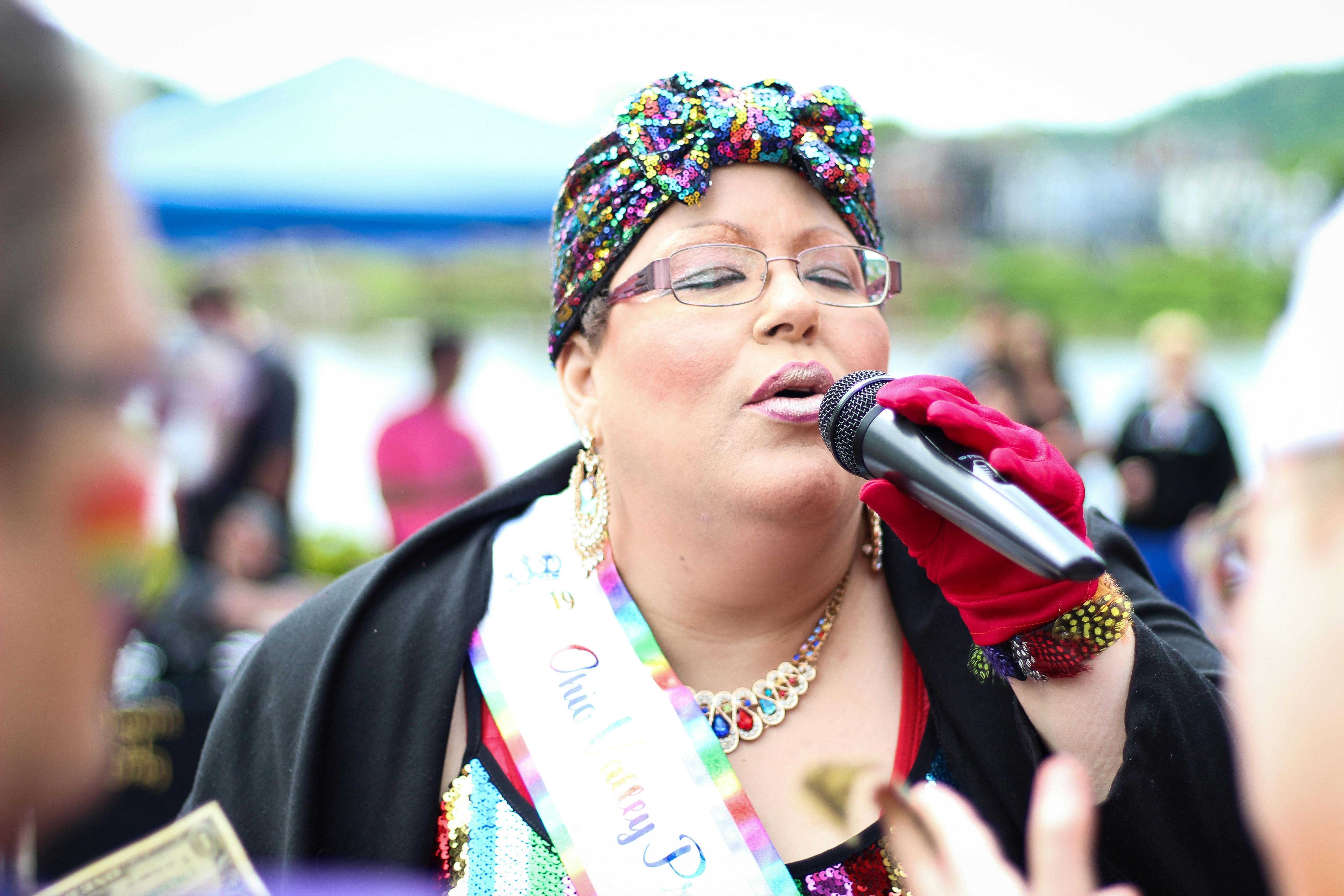 woman holding black wireless mic