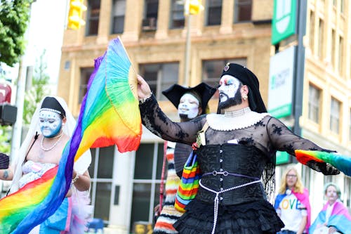 People Holding Rainbow Hand Fans