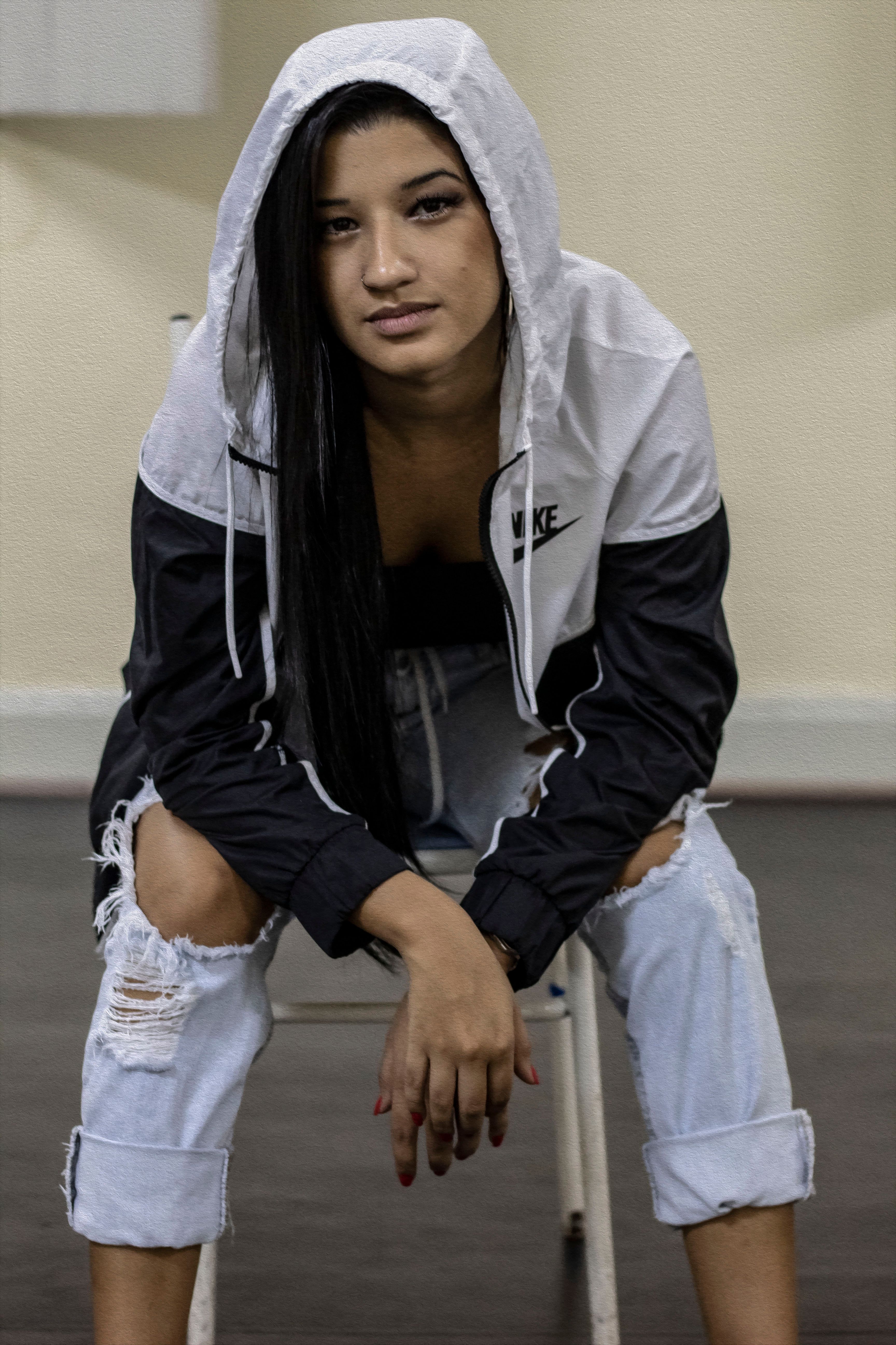 Stylish woman posing confidently indoors in casual fashion.