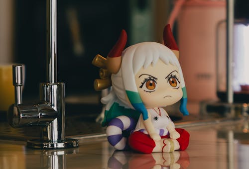 A small figurine sitting on a counter top