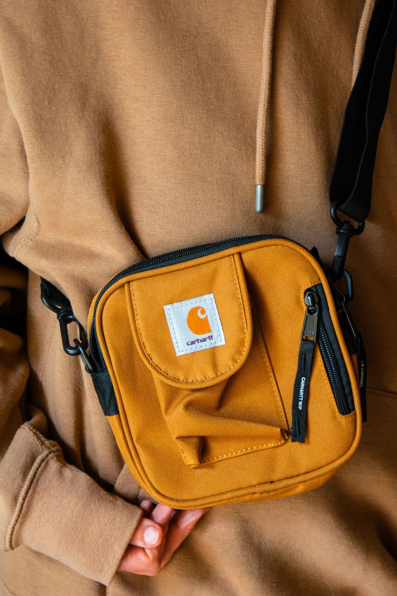 Mustard crossbody bag paired with beige outfit