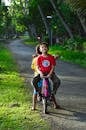 Boy Riding on Back of Bicycle