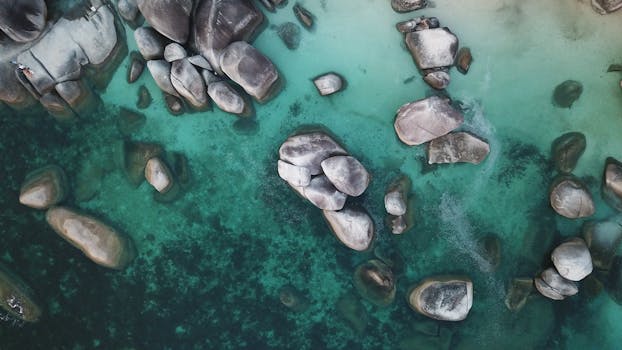 Drone shot capturing the stunning rocky coastline at Sijuk, Kepulauan Bangka Belitung, Indonesia.