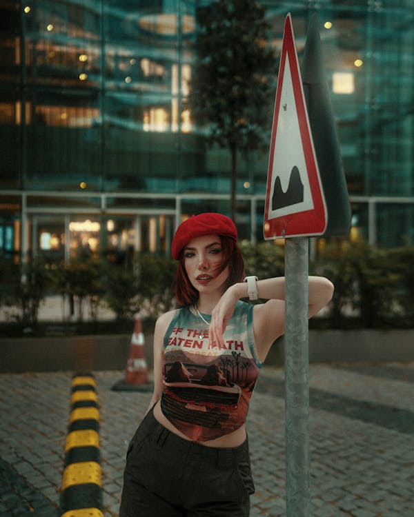 A woman posing in front of a street sign