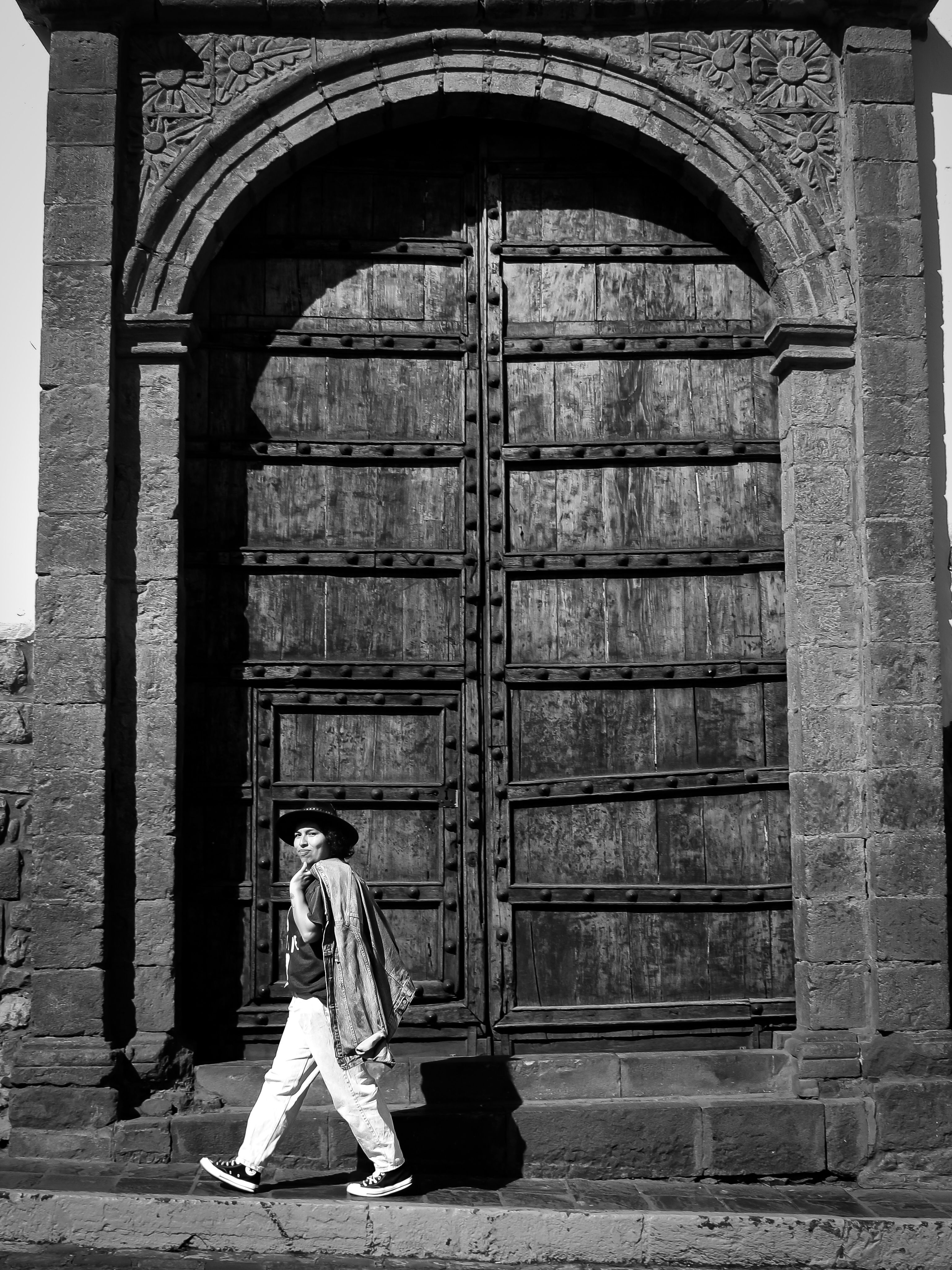 Black and White Photo of a Woman Walking Past Old, Wooden Door · Free ...