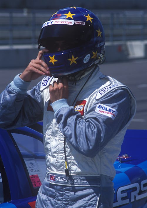 Man in Blue and and White Racer Suit Wearing His Blue and Yellow Star Full Face Helmet