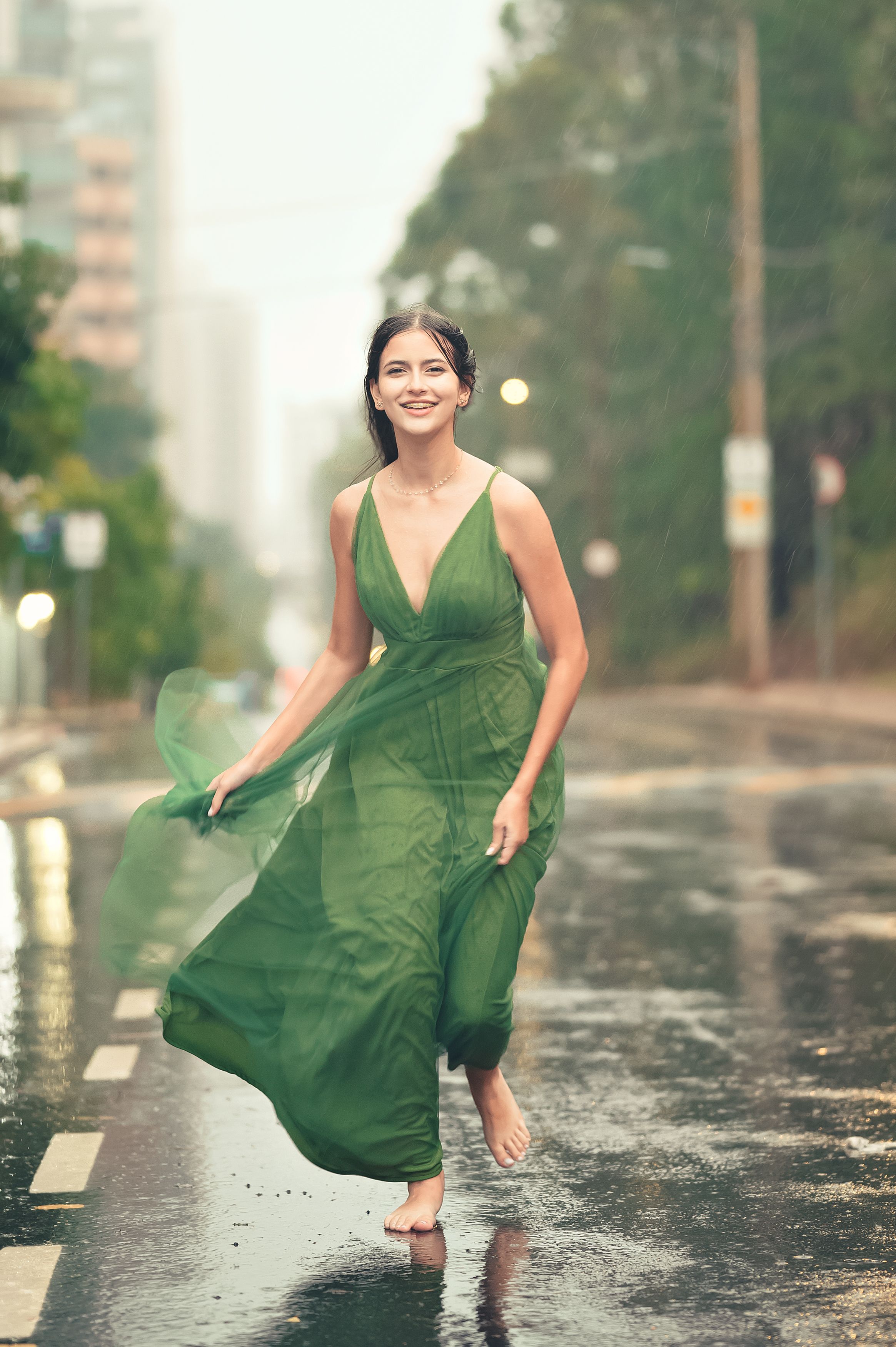 Smiling Woman Walking in Green Dress Barefoot on Street in Rain  Free  Stock Photo