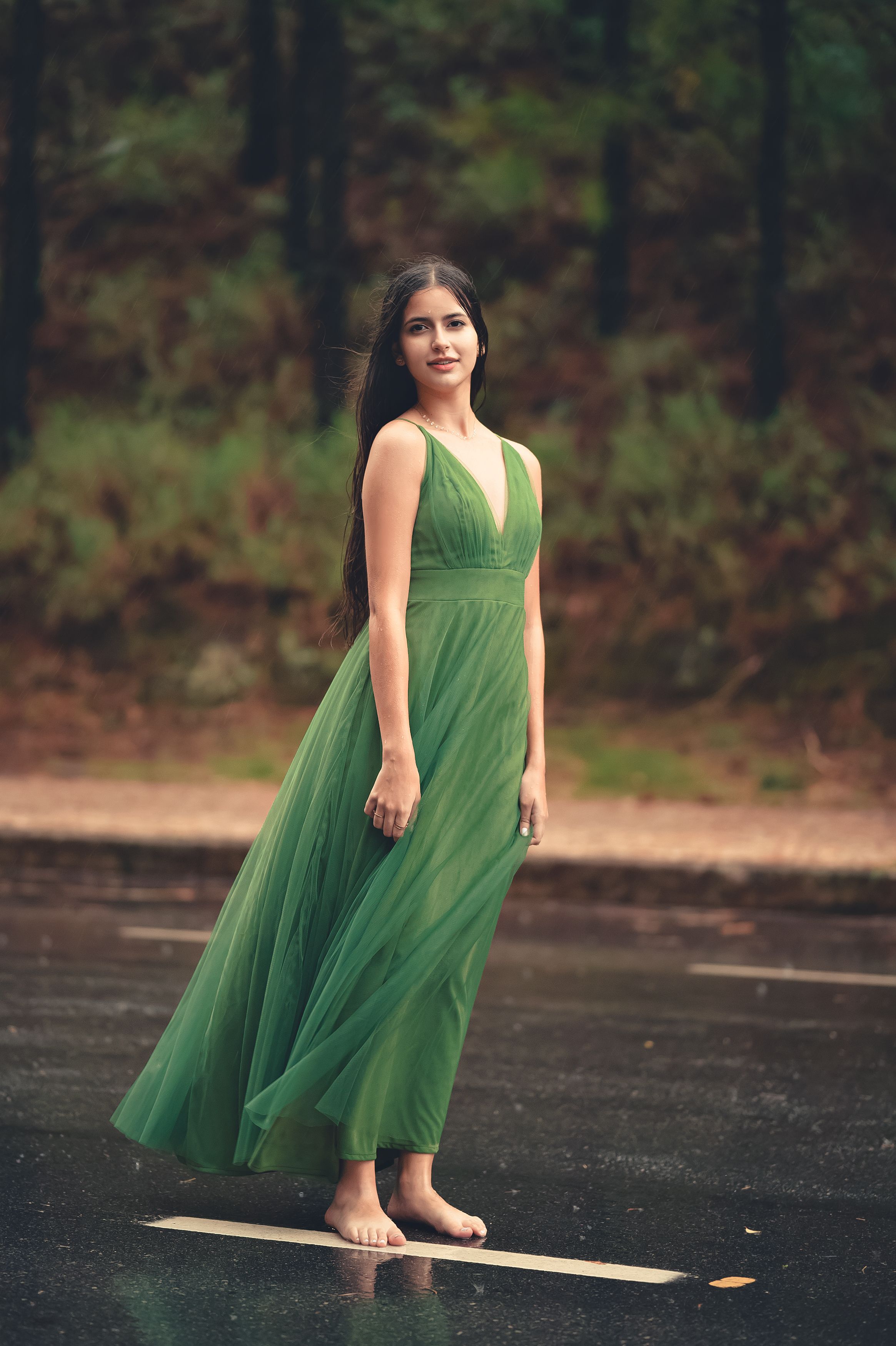 Portrait of a Barefoot Woman in Long Green Dress Standing on the Road ...
