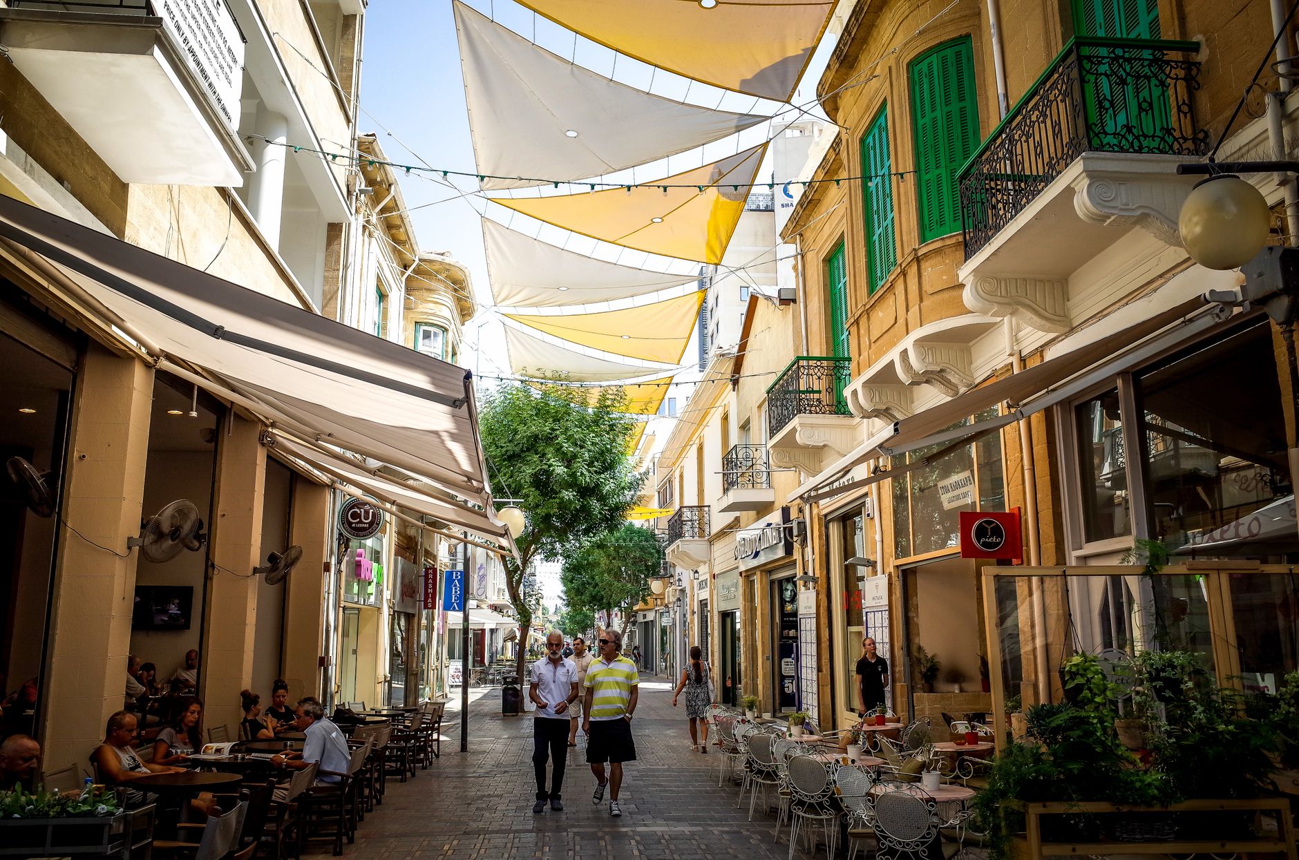 Busy cafés and shops along a street in Nicosia
