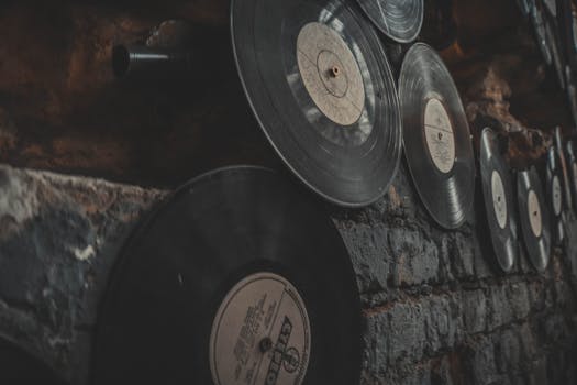 Close-up of vintage vinyl records displayed on a rustic brick wall, creating an artistic, nostalgic atmosphere.