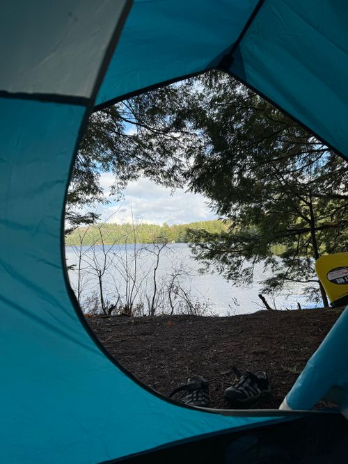 Free Serene lakeside view from inside a tent, perfect for a tranquil camping getaway in Ontario, Canada. Stock Photo