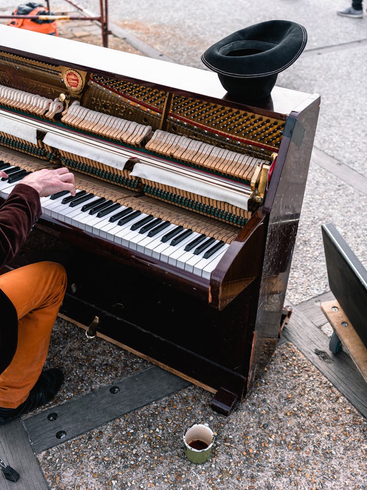 Man Playing Brown Upright Piano