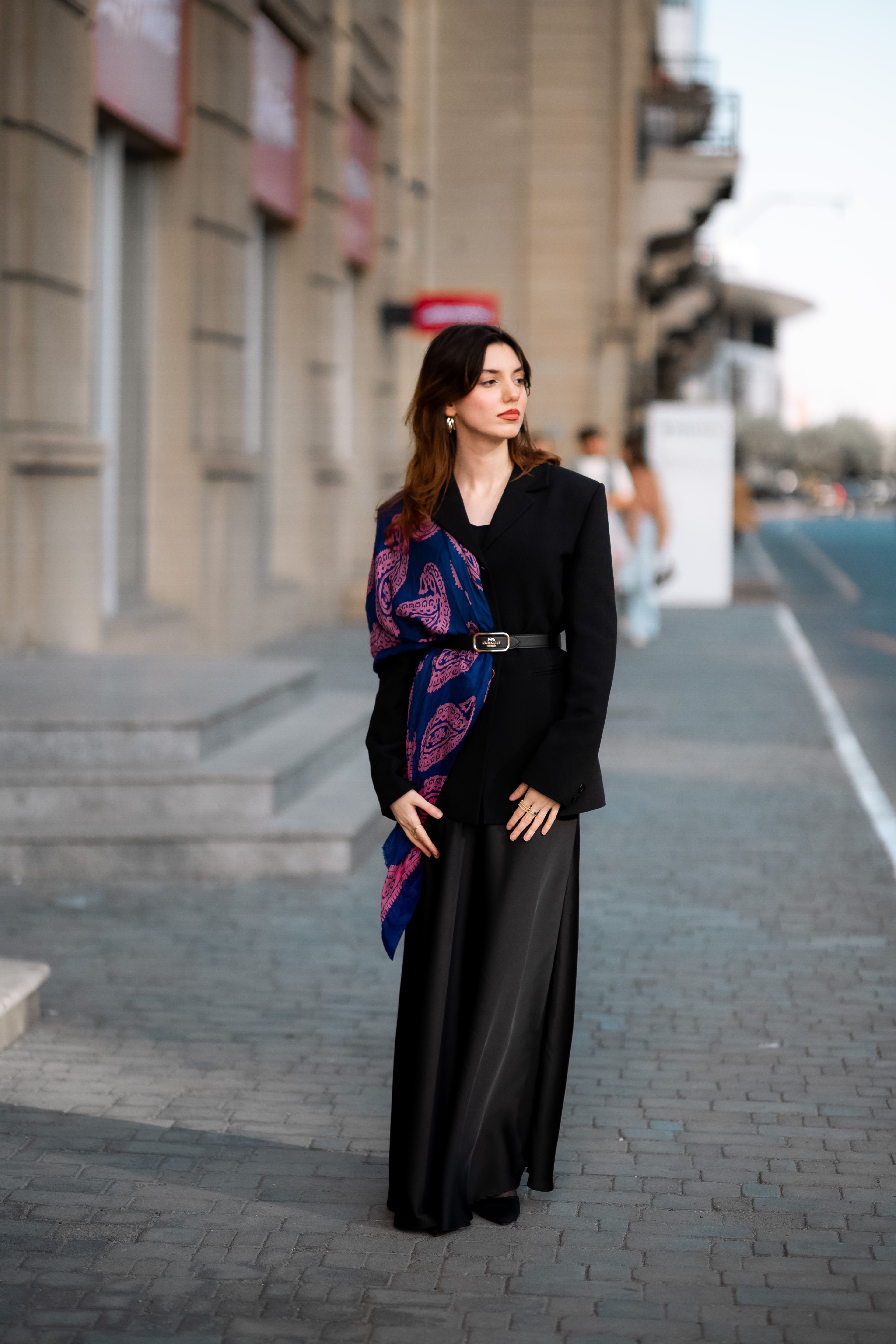 A Fashionable Woman Posing on a Sidewalk · Free Stock Photo