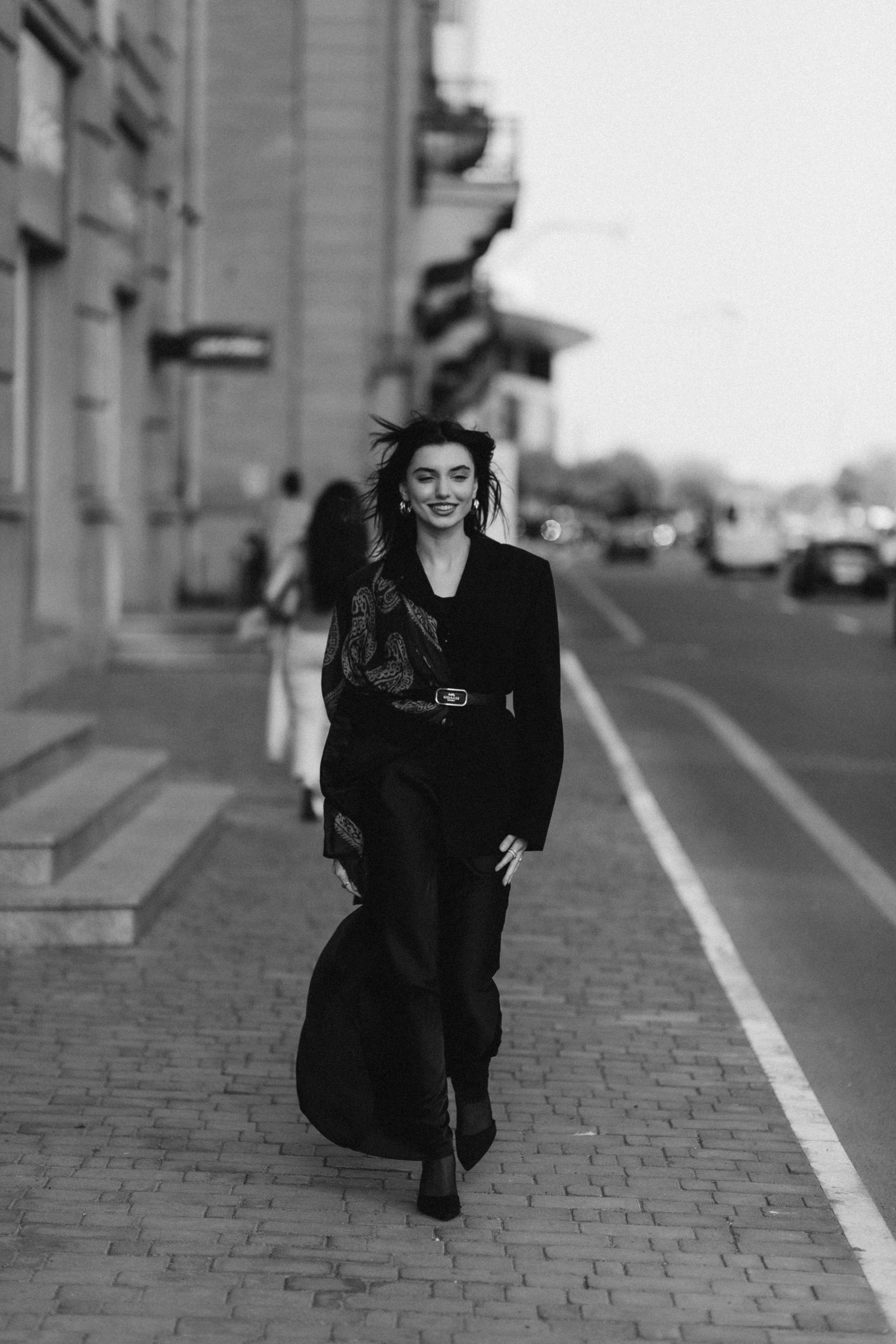 A Fashionable Woman Posing on a Sidewalk · Free Stock Photo