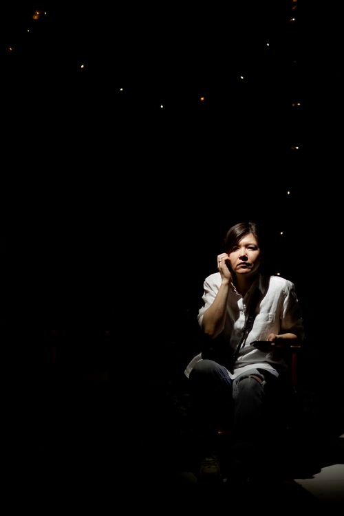 A Woman Sitting in a Dark Room · Free Stock Photo
