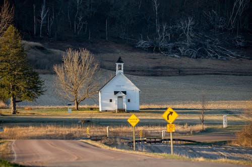 A white church sits on a country road
