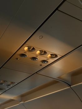 Close-up view of overhead cabin panel in airplane. Modern design and controls.
