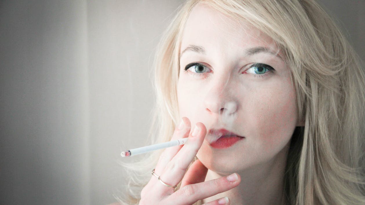 Free stock photo of blonde, woman smoking Stock Photo