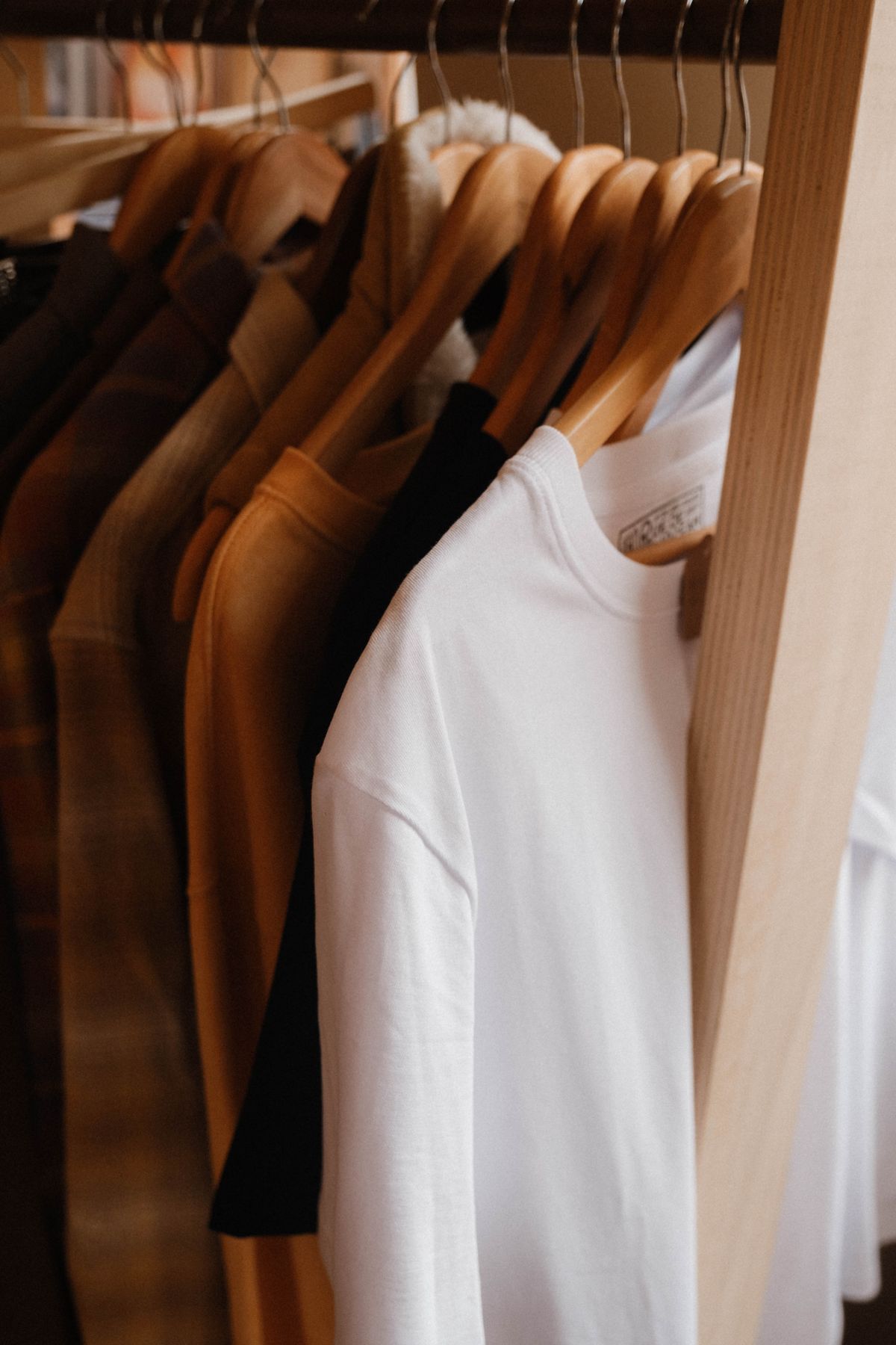 Minimalist fashion pieces hanging on a clean rack