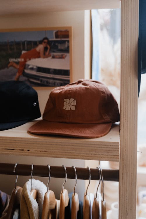 A hat rack with a brown hat on it