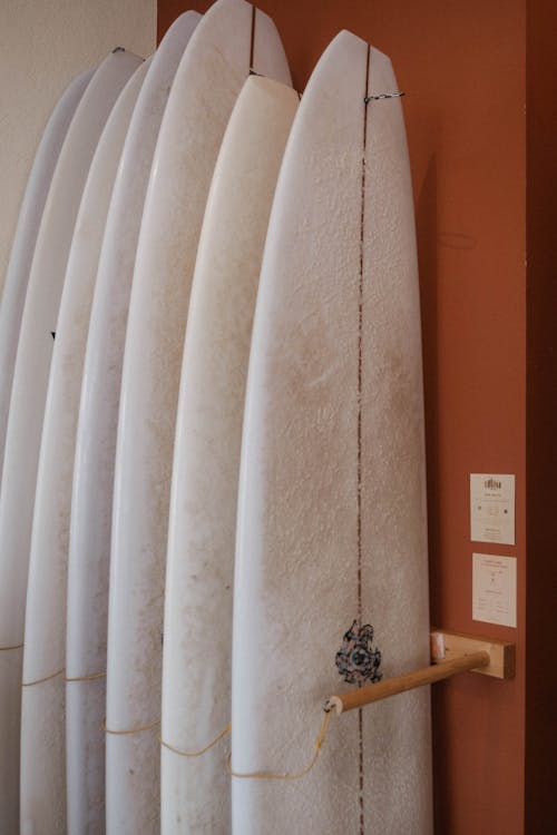 A rack of surfboards with a wooden handle