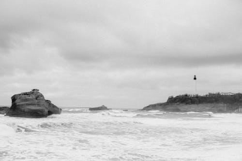 Black and white photo of a lighthouse on the beach