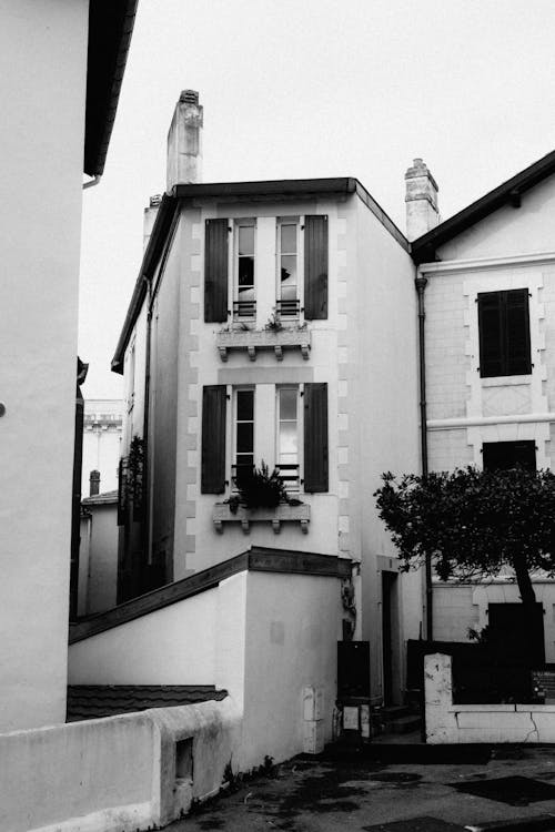 Black and white photo of a building with shutters