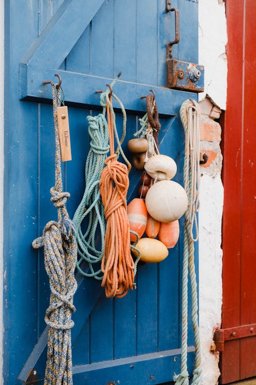 A blue door with rope hanging from it