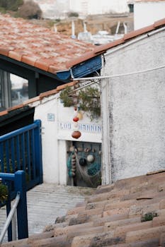 Picturesque view of a traditional house in Biarritz, France with terra-cotta roof and coastal decorations.