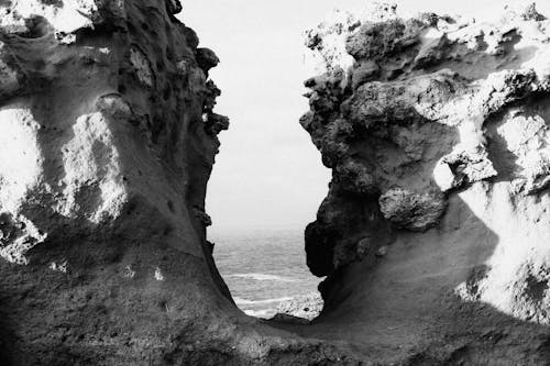 Black and white photograph of two rocks in the ocean