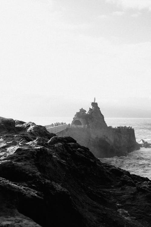 Black and white photo of a lighthouse on the ocean
