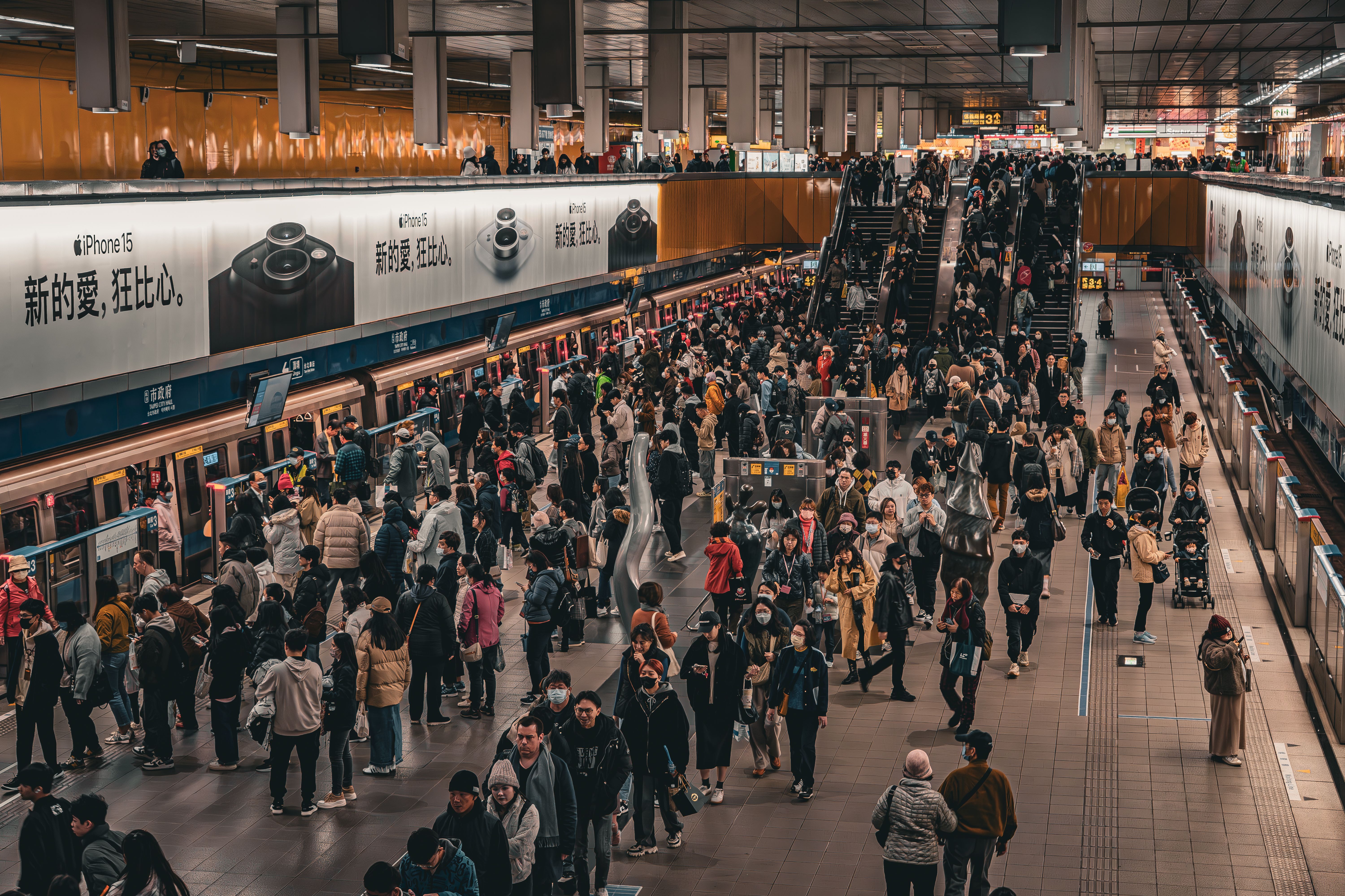 Overhead view of a bustling crowd at a metro station platform in Taipei, Taiwan.