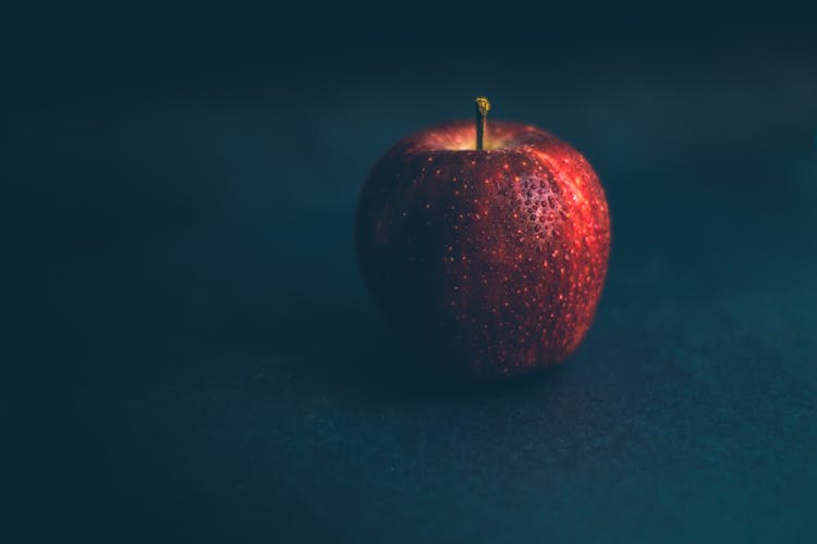 Red Apple Fruit On Dark Background With Water Drops