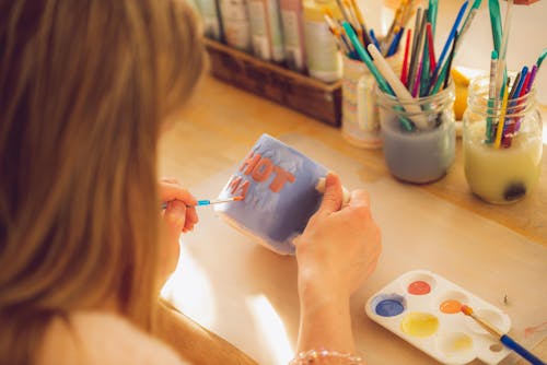 Free Person Painting on Mug Stock Photo