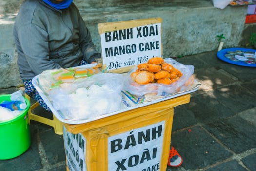 Mango cakes on a street market stall in Vietnam. Highlighting local cuisine and urban culture.