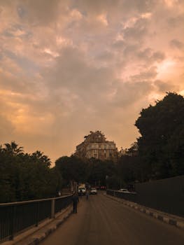 A captivating view of Cairo's architecture with a dramatic sunset sky adding warmth to the scene.