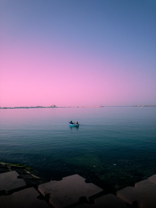 A person in a small boat in the water