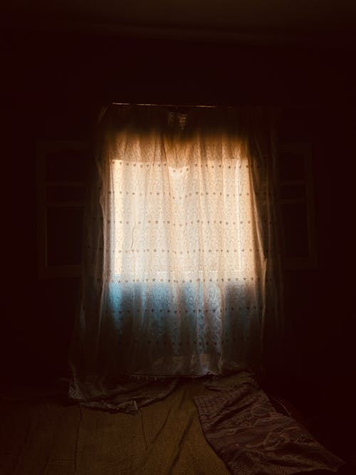 A window with curtains in the dark