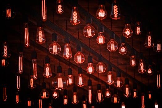 Multiple red-tinted vintage light bulbs hanging, creating a retro ambiance with a warm glow.