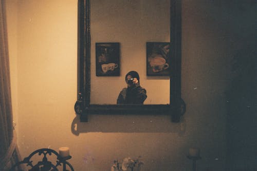A person taking a picture of themselves in a mirror
