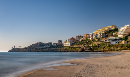 Beach beside a lighthouse, photo by Rafael Minguet Delgado on Pexels