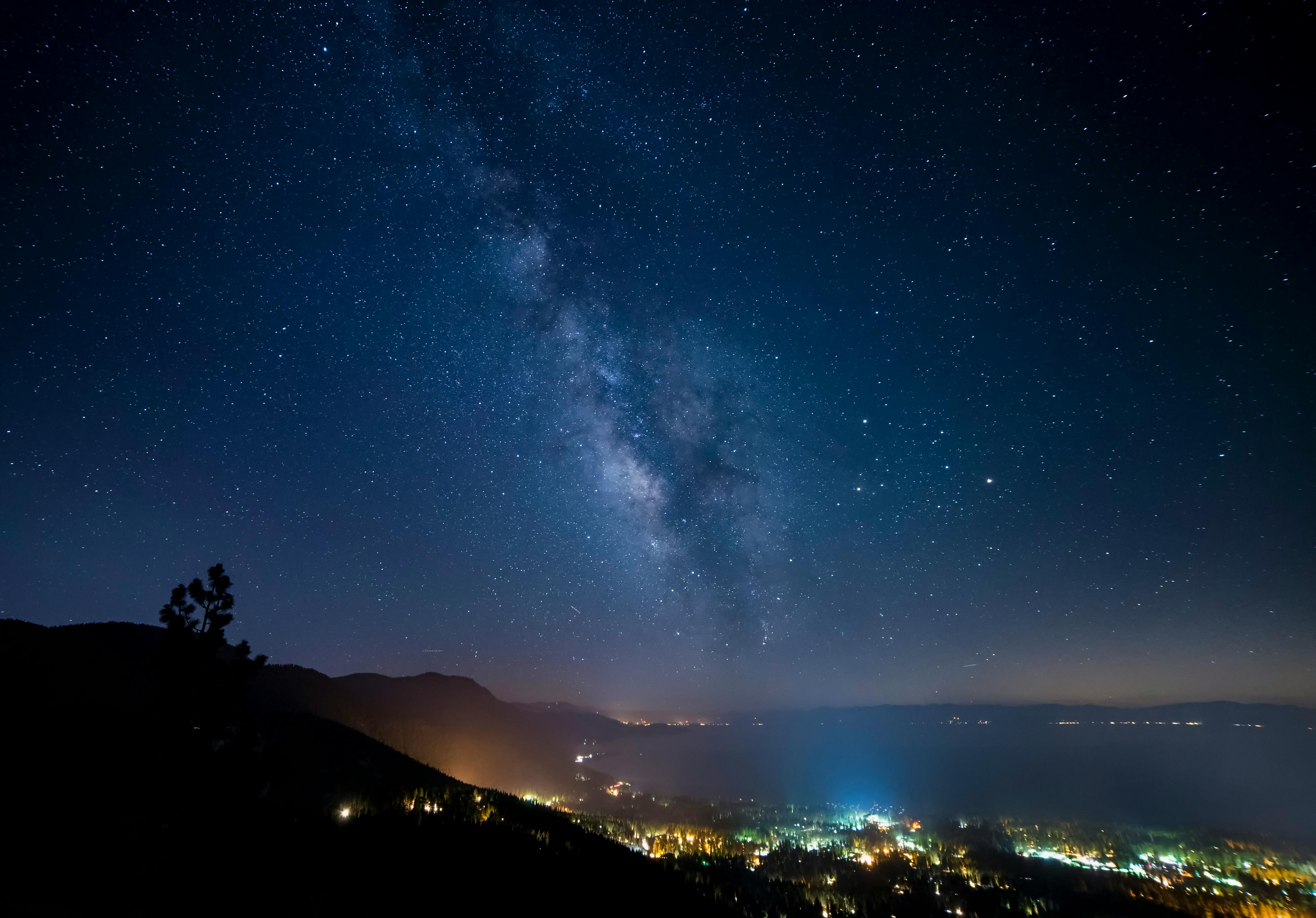 city with lights under a starry sky